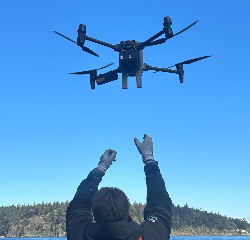 Man catching a drone on a boat