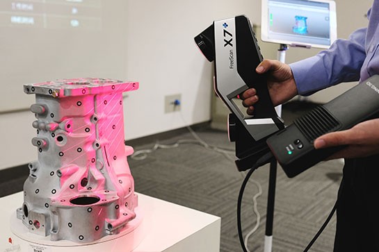 Metal Object with markers being 3D scanned. Photo belongs to momentum 360.